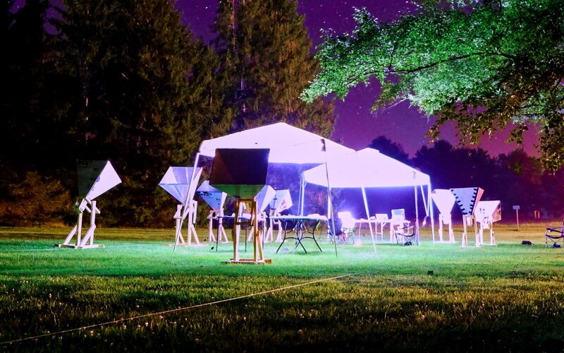 Horn telescopes and a lit tent under a field of stars at Green Bank.