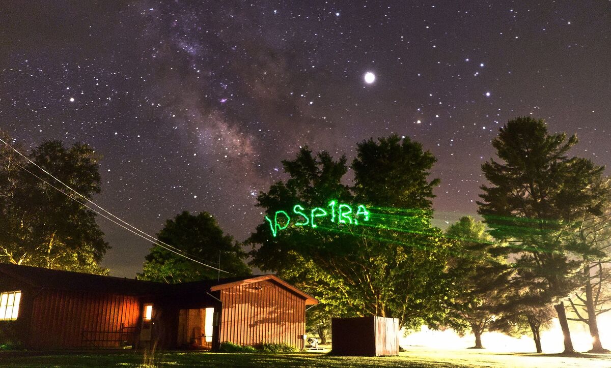 The Milky Way over the Green Bank Observatory site, with DSPIRA
                      written in the air by a hand-held light.