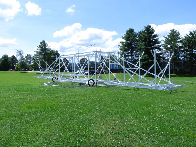 Jansky's rotating antenna: a long white girder framework on wheels that rides a circular ground track, more like scaffolding than a dish